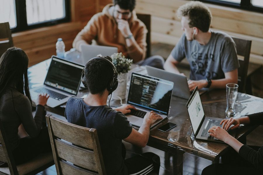 A team with laptops at a table